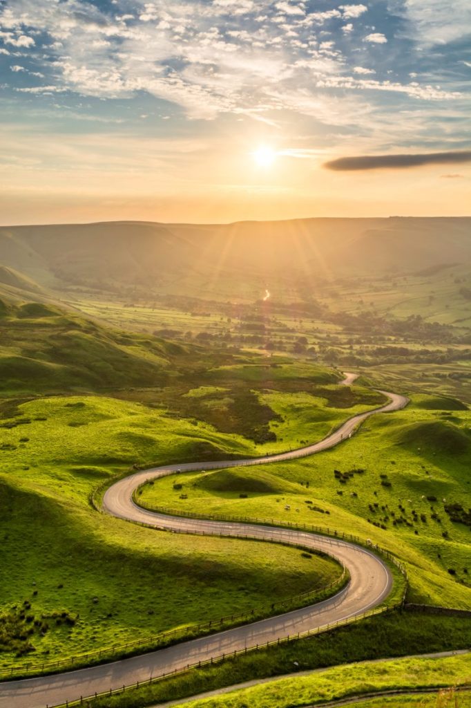 A,Long,And,Winding,Road,Passing,Through,Green,Hills,At